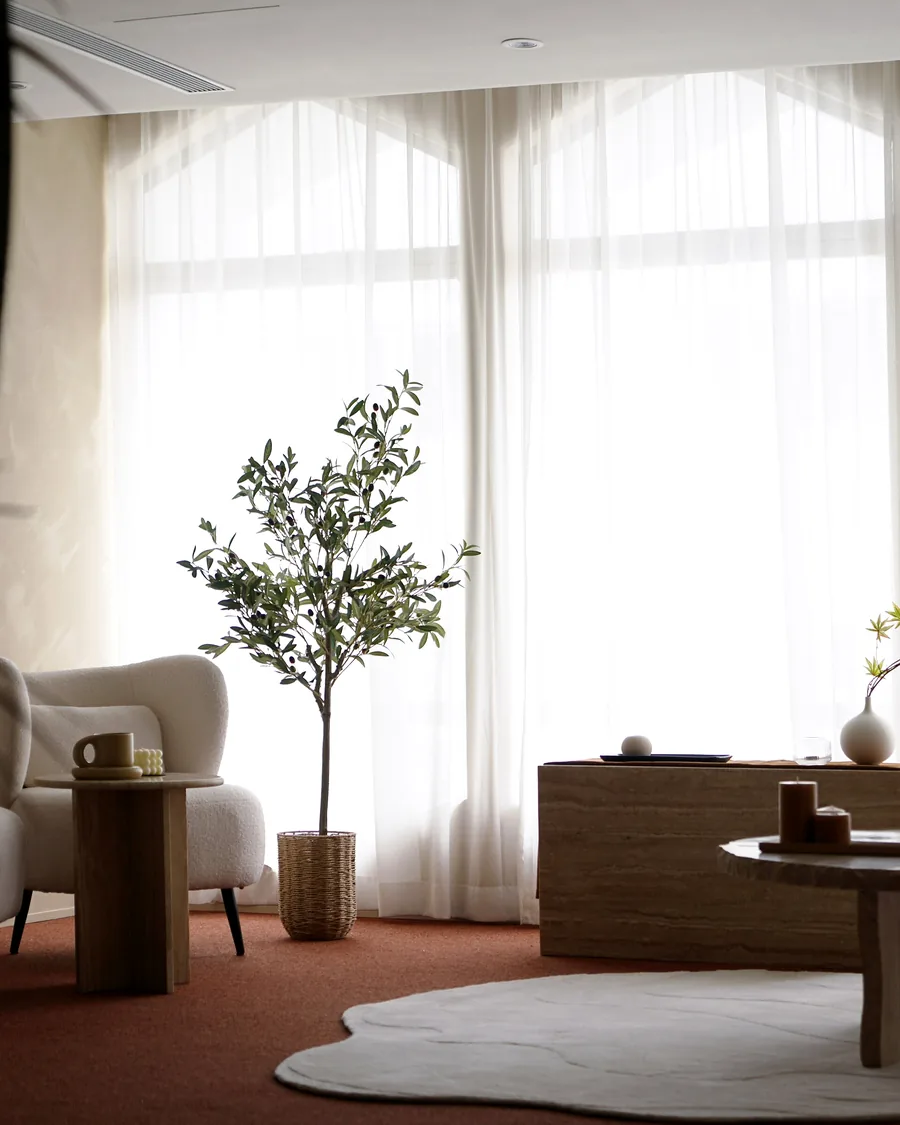 A bright lounge with armchairs and tall windows